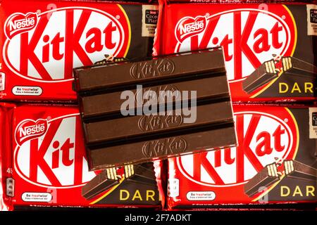 3 April 2021, Wuhan China: KitKat dark a chocolate wafer bar close-up view opened on Kit Kat background in their packaging Stock Photo