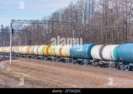 Long freight train approaches to the station. Stock Photo