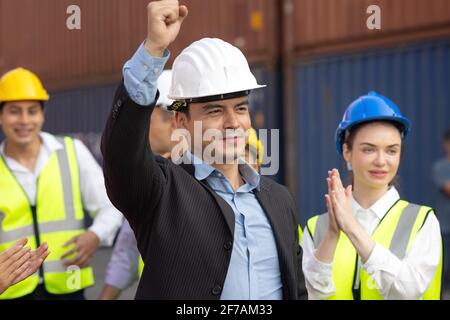 Unity and success concept.Bottom view of Engineer team people standing hands holding together at the container yard. Stock Photo