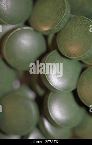 Green pills close up medical spirulina platensis algae family algaespace modern trendy food high quality big size print Stock Photo