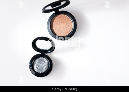 Beautiful eye shadow with sparkles, in a black single jar. The shadows are glossy, cream. Stock Photo