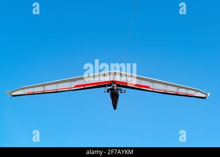 Pilot on modern high performance hang glider. Aviation athlete. Stock Photo
