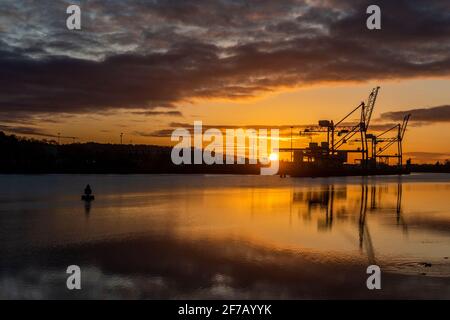 Cork, Ireland. 6th Apr, 2021. The sun rises over Tivoli Docks in the Port of Cork as a prelude to a day of sunshine with highs of 5 to 7C. Credit: AG News/Alamy Live News Stock Photo
