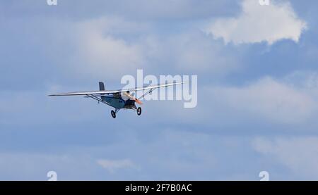 ICKWELL, BEDFORDSHIRE, ENGLAND - SEPTEMBER 06, 2020: Vintage 1931 Civilian Coupe 02 G-ABNT  aircraft in flight  against blue sky and clouds. Stock Photo