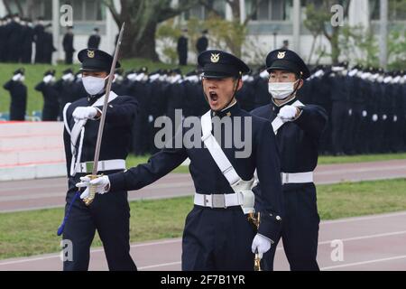 Students of the National Defense Academy parade the Japanese flag 