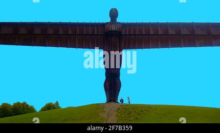 'Angel of the North' giant scupture in 2017 - blue sky . Children beneath it give a sense of its size. ----- The iconic scupture (The largest in Britain) was designed by Antony Gormley and built by  Hartlepool Steel Fabrications Ltd using  COR-TEN weather-resistant steel and was completed in 1998. It's located near to  Gateshead, Tyne and Wear, England and is now recognised now as both a landmark and  a symbol of the north eastern area of England and its industrial heritage. Efforts to have the sculpture to be officially listed  as of historic interest  have so far been unsuccessful.