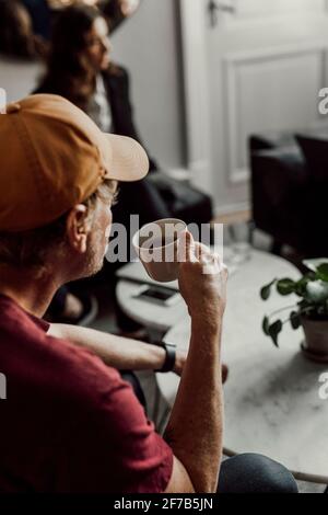 Man having coffee during office meeting Stock Photo