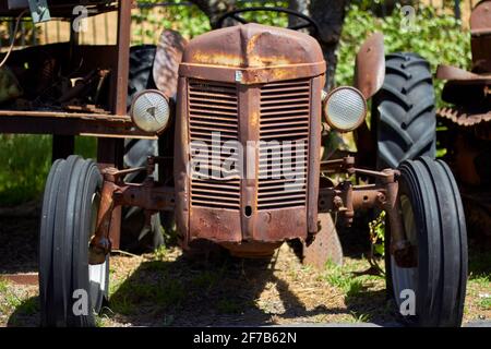 Old Abandoned Tractor Farm Equipment Left to Rust in Field Stock Photo