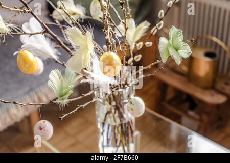 Twigs with hanging Easter eggs Stock Photo