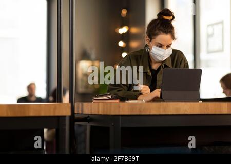 Woman in cafe using digital tablet Stock Photo