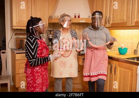 Women preparing sausages in kitchen Stock Photo