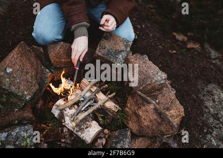 Woman preparing campfire Stock Photo