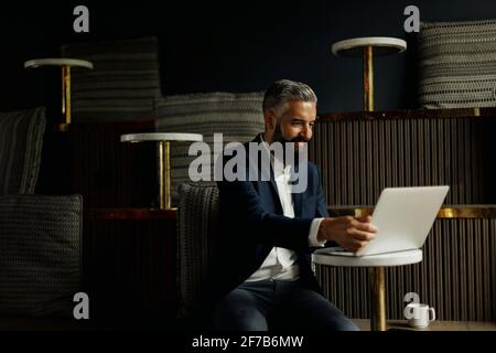 Businessman using laptop in cafe Stock Photo