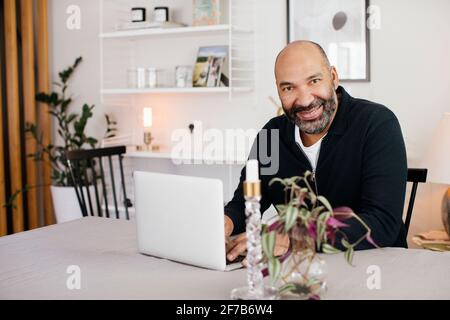 Man using laptop at home Stock Photo