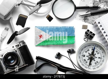 Flag of Djibouti and travel accessories on a white background. Stock Photo