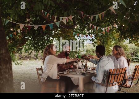 Friends having meal in garden Stock Photo