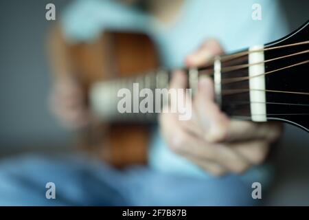 Blurred photo of a man playing acoustic guitar for background Stock Photo