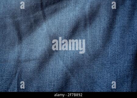 Blue denim jeans textile with creases texture background Stock Photo