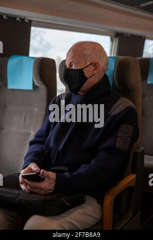 Senior man traveling by train Stock Photo