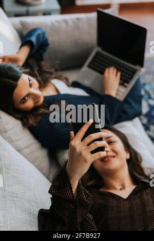 Female coworkers on sofa Stock Photo