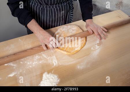 Woman's hands rolling dough Stock Photo