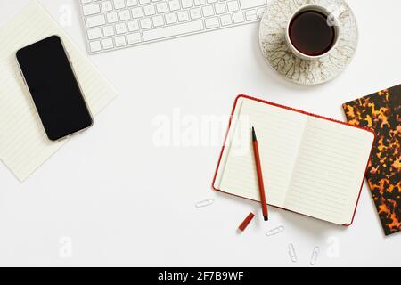 Coffee and notepad on desk Stock Photo