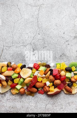 Various dried fruits and nuts on a gray concrete background Stock Photo