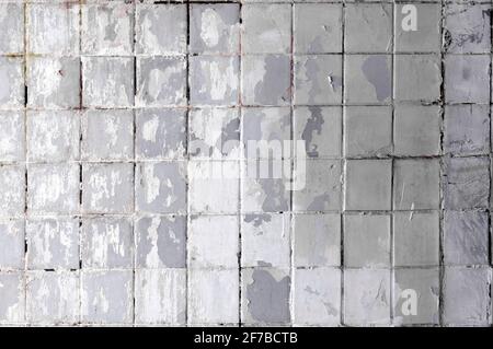 Dirty wall with old tiles. Rough wall texture. Background. Stock Photo