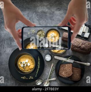pumpkin soup in black plates Stock Photo