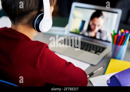 Rear view of boy during homeschooling Stock Photo