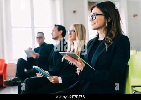 Seminar presenter at corporate conference giving speech workshop discussion in hall during company training event. Stock Photo