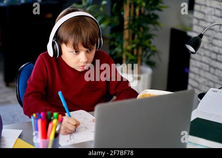 Focused schoolboy practicing his handwriting Stock Photo