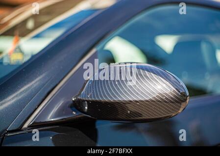 Detail of the rearview mirror in carbon fiber of the car tuning Stock Photo