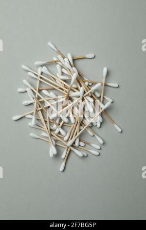 Heap of wooden cotton swabs on light gray background Stock Photo