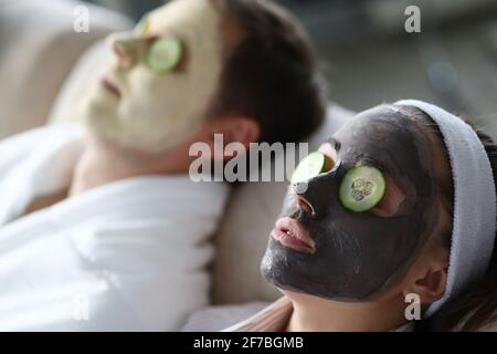 Man and woman make rejuvenating clay mask to restore facial skin