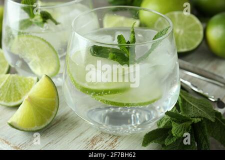 Board with glasses of mojito cocktail and ingredients, close up. Wooden board with glasses of mojito cocktail and ingredients, close up Stock Photo