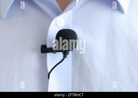 Lapel microphone is worn on men blue shirt Stock Photo