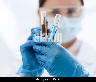 close up. female scientist marks tubes with tests. Stock Photo