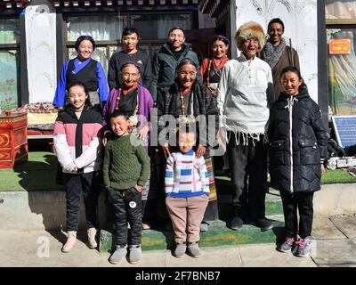 (210406) -- LHASA, April 6, 2021 (Xinhua) -- Dacho (C) poses for a photo with her family members at home in Lalho Township, Saga County of Xigaze, southwest China's Tibet Autonomous Region, Jan. 14, 2021. Dacho, born in 1929, is a resident in Lalho Township, Saga County of Xigaze, southwest China's Tibet Autonomous Region. She was made a serf in her early childhood and had suffered an unimaginable ordeal until the democratic reform in 1959.'The serf owner kept a roster listing dates of birth of all local residents, who would be made serfs at certain age, regardless of gender or health conditio Stock Photo