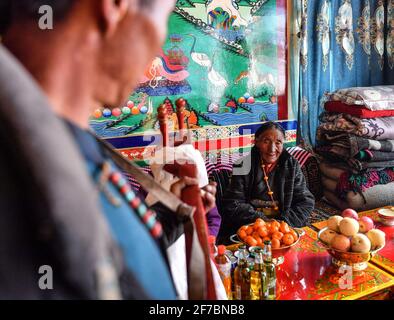 (210406) -- LHASA, April 6, 2021 (Xinhua) -- Family members sing a toast song for Dacho at home in Lalho Township, Saga County of Xigaze, southwest China's Tibet Autonomous Region, Jan. 14, 2021. Dacho, born in 1929, is a resident in Lalho Township, Saga County of Xigaze, southwest China's Tibet Autonomous Region. She was made a serf in her early childhood and had suffered an unimaginable ordeal until the democratic reform in 1959.'The serf owner kept a roster listing dates of birth of all local residents, who would be made serfs at certain age, regardless of gender or health condition,' Dacho Stock Photo