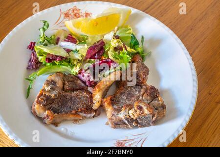 Typical Easter dish in Abruzzo, grilled lamb meat and mixed salad. Abruzzo, Italy, Europe Stock Photo