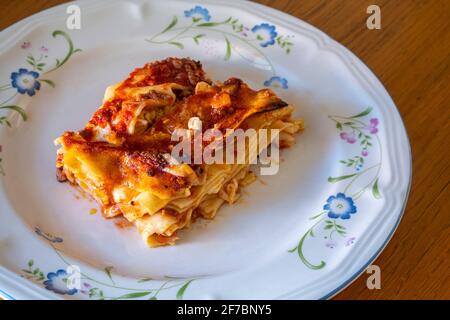 Portion of homemade lasagna with eggs, tomato sauce, handmade pasta, ragù and mozzarella. Typical Italian dish. Abruzzo, Italy, Europe Stock Photo