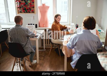 Two seamstresses are exchanging looks during work Stock Photo