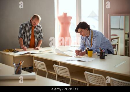 Drawing process in a classroom performed by two tailors Stock Photo