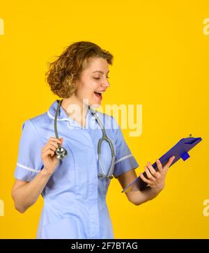 woman doctor with stethoscope and folder. medical doctor holding a folder. nurse holding patient medical chart. Nurse holding folder and taking notes Stock Photo