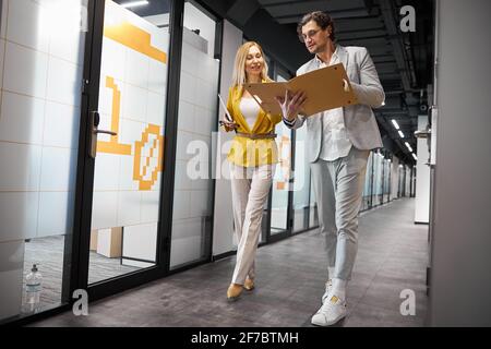 Attentive bearded man checking folder with documents Stock Photo