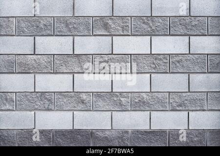 Gray brick wall, masonry pattern, concrete background, cement block texture, grunge architectural element. Abstract backdrop. Building's facade. Urban Stock Photo