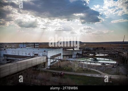 Outdated Soviet mining and processing factory. Water purification plant. Panorama view. Title on building: Labor Glory. Stock Photo