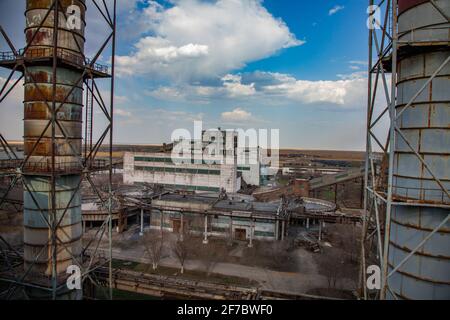 Outdated Soviet mining and processing plant. Smoke stacks and industrial building. Stock Photo