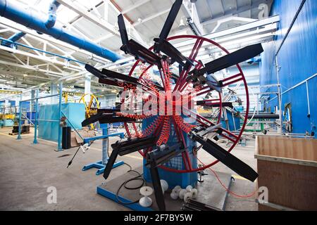 Stepnogorsk, Kazakhstan - April 04, 2012: Plastic pipes production plant. Rolling machine for small-diameter tubes and hoses, packing machine. Stock Photo